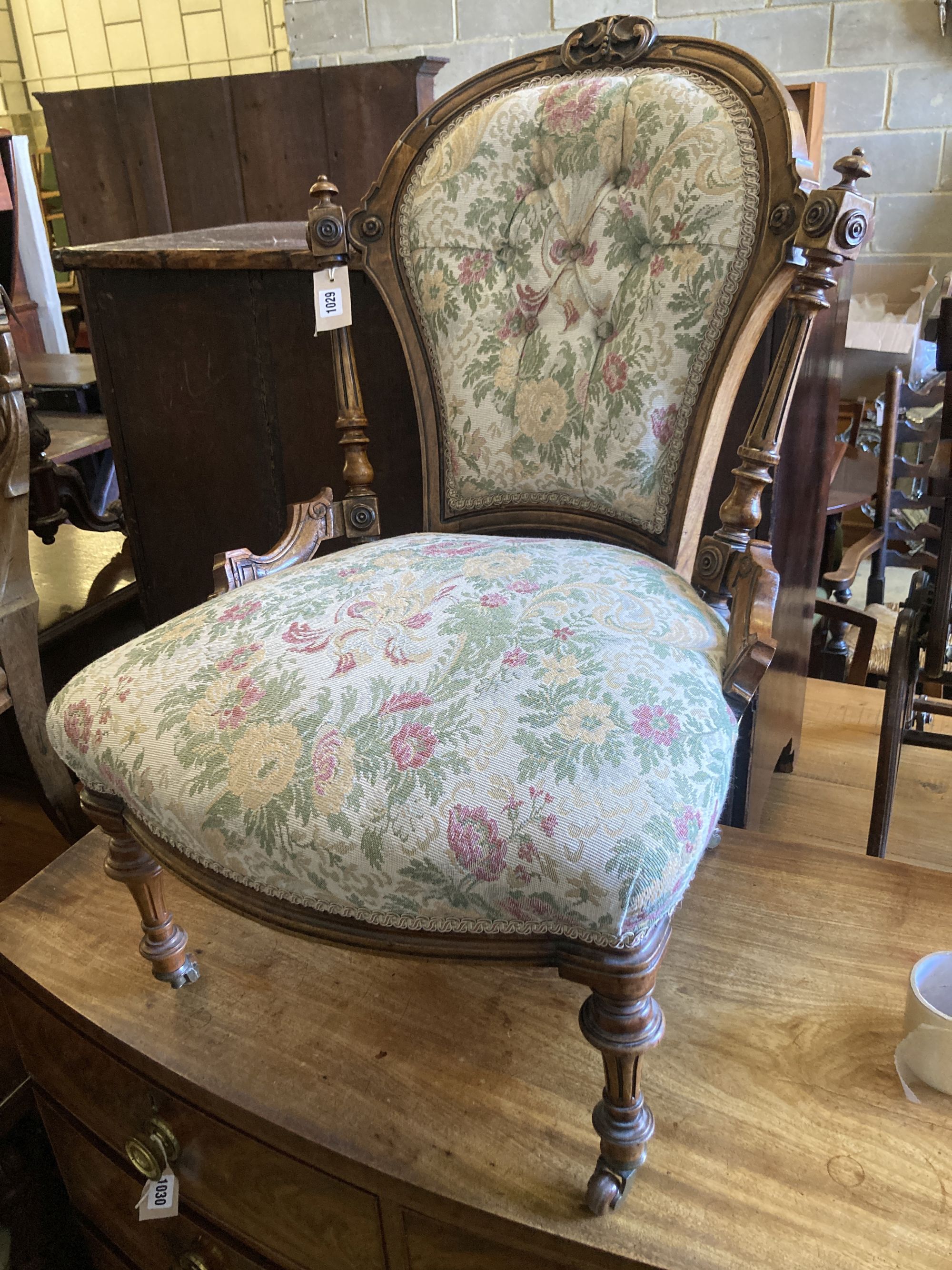 A Victorian carved walnut spoon back nursing chair, width 54cm, depth 56cm, height 80cm